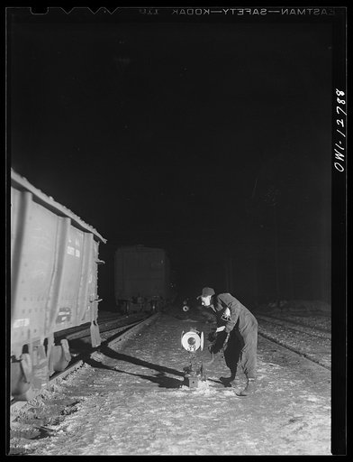 Chicago, Illinois. Throwing a switch during switching operations at one of the Chicago and Northwestern Railroad classification yards
