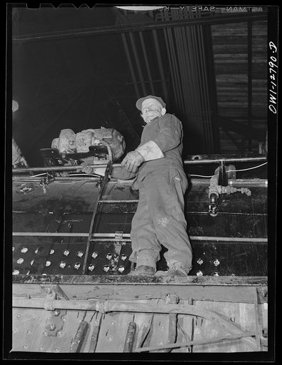 Untitled photo, possibly related to: Chicago, Illinois. Working on a locomotive at the Chicago and Northwestern repair shops