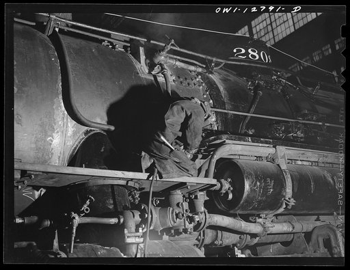 Untitled photo, possibly related to: Chicago, Illinois. Working on a locomotive at the Chicago and Northwestern repair shops