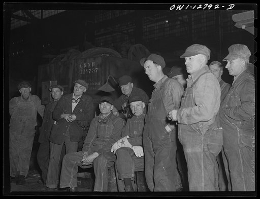 Chicago, Illinois. Men of the night shift listening to a report of the safety committee before starting to work at the Chicago and Northwestern Railroad repair shops