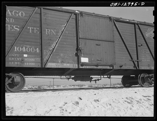 Chicago, Illinois. Car going toward the hump at a yard of the Chicago and Northwestern Railroad. In the background is a new village that has sprung up since the construction of a war plant