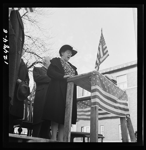 Chicago (north), Illinois. Mrs. Alice Burns, who sings on the local radio station, leading the singing of the national anthem at a neighborhood flag dedication ceremony