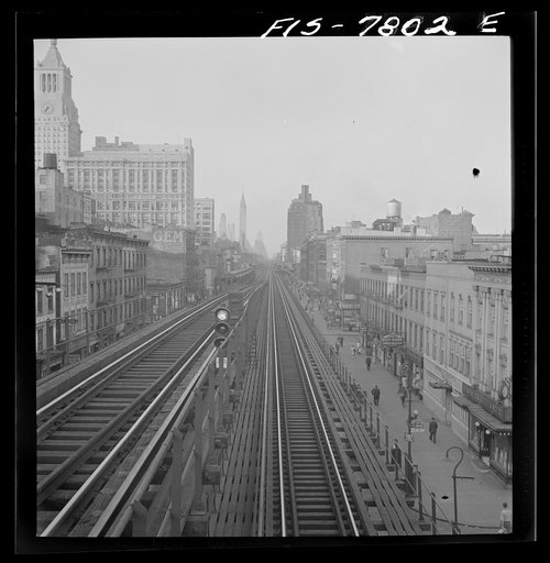 Untitled photo, possibly related to: New York, New York. Looking north from the Ninth Street station on the Third Avenue elevated railway as a train leaves on the local track