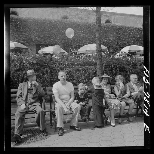 New York, New York. Sunday bench sitters in front of the Central Park Zoo restaurant