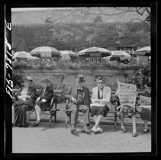 New York, New York. Sunday bench sitters in front of the Central Park Zoo restaurant