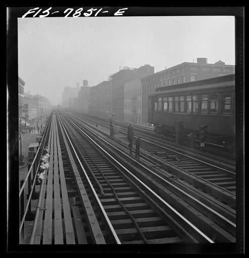 New York, New York. Signaller on the track of the Third Avenue elevated railway near 14th Street in the early morning