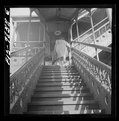 New York, New York. Third Ave elevated railway steps at the 94th Street Station in the early morning