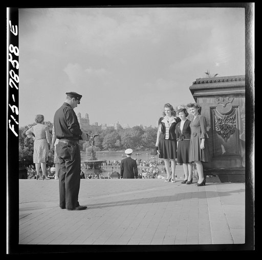 New York, New York. Policeman obliges three Sunday stroller in Central Park by taking their photographs