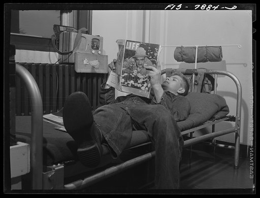 Untitled photo, possibly related to: Fort Belvoir, Virginia. Sergeant George Camblair reading an article in a magazine while relaxing after dinner