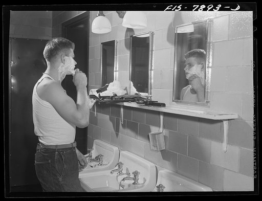 Fort Belvoir, Virginia. Sergeant George Camblair shaving in the morning at the camp