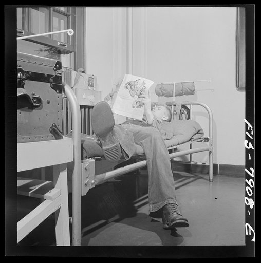 Untitled photo, possibly related to: Fort Belvoir, Virginia. Sergeant George Camblair reading an article in a magazine while relaxing after dinner