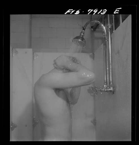 Untitled photo, possibly related to: Fort Belvoir, Virginia. Sergeant George Camblair taking a shower before dinner at camp