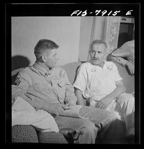 Washington, D.C. Sergeant George Camblair discussing the war with his father while on a visit home