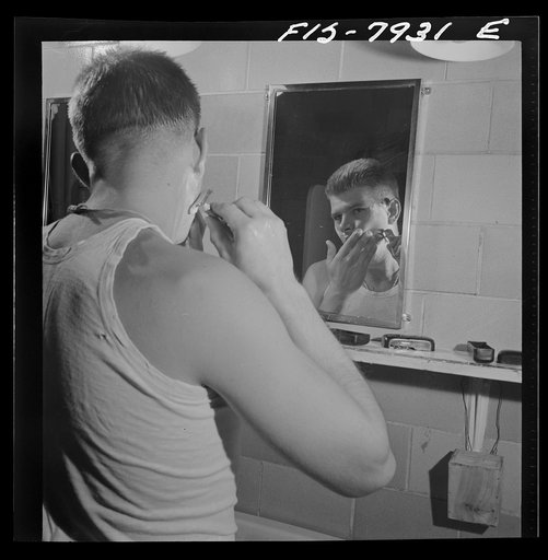 Fort Belvoir, Virginia. Sergeant George Camblair shaving in the morning at the camp