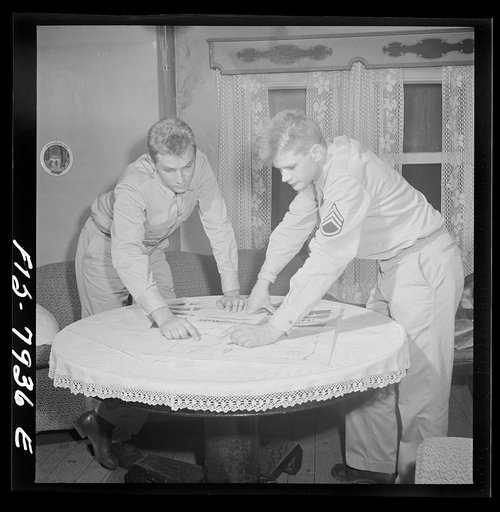 Untitled photo, possibly related to: Washington, D.C. Sergeant George Camblair while on a visit home finds that his younger brother is at home also on a furlough from the Army
