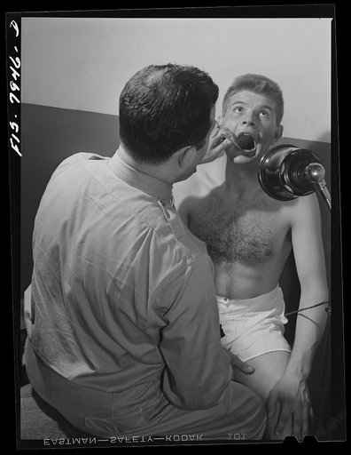 Baltimore, Maryland. The ear, nose and throat doctor examining George Camblair at the induction station
