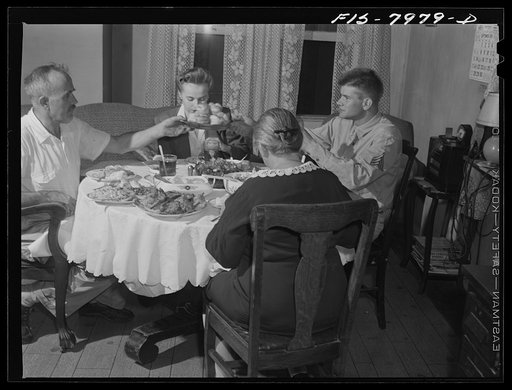 Untitled photo, possibly related to: Washington D.C. Sergeant George Camblair and his girlfriend having dinner with his family while he is at home on a weekend furlough