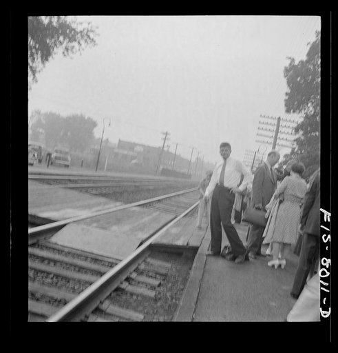 Untitled photo, possibly related to: Silver Spring, Maryland. George Camblair waiting at the station for the train which will take him to the induction center