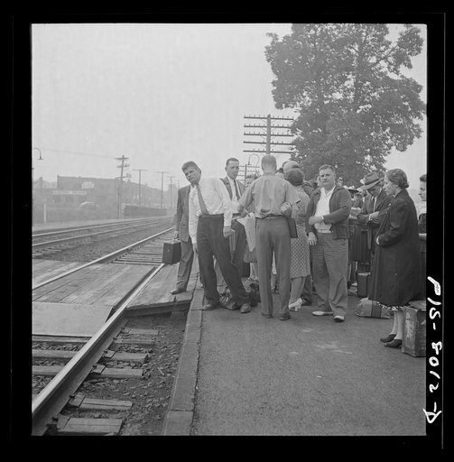 Silver Spring, Maryland. George Camblair waiting at the station for the train which will take him to the induction center