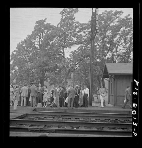 Silver Spring, Maryland. George Camblair waiting at the station for the train which will take him to the induction center