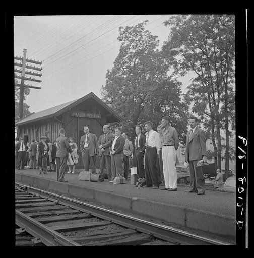 Silver Spring, Maryland. George Camblair waiting at the station for the train which will take him to the induction center