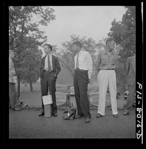 Silver Spring, Maryland. George Camblair waiting at the station for the train which will take him to the induction center
