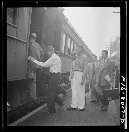 Silver Spring, Maryland. George Camblair waiting at the station for the train which will take him to the induction center