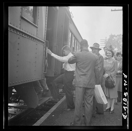 Silver Spring, Maryland. George Camblair waiting at the station for the train which will take him to the induction center