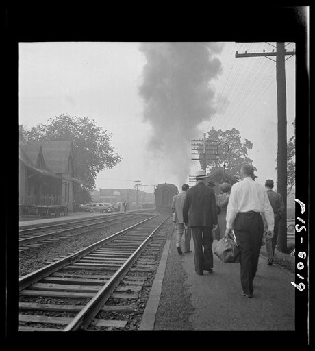 Untitled photo, possibly related to: Silver Spring, Maryland. George Camblair waiting at the station for the train which will take him to the induction center