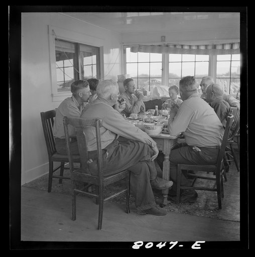Big Hole Valley, Beaverhead County, Montana. Ranchers and cattle buyers eating dinner at ranch. Buyers from the middle west come out to the ranches in the fall to select feeder cattle
