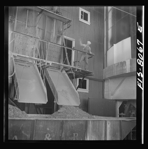 Untitled photo, possibly related to: Butte, Montana. Anaconda Copper Mining Company. Loading copper ore into cars for transporting to smelter