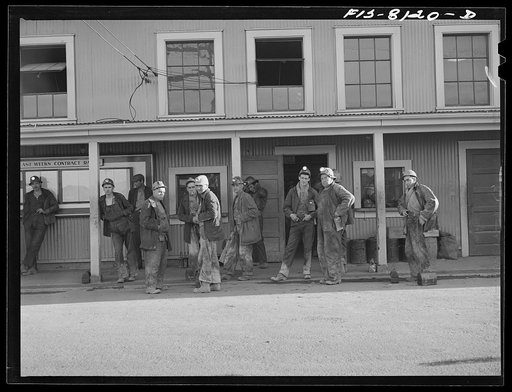 Butte, Montana. Anaconda Copper Mining Company. Miners outside change-room at headframe of mountain con mine