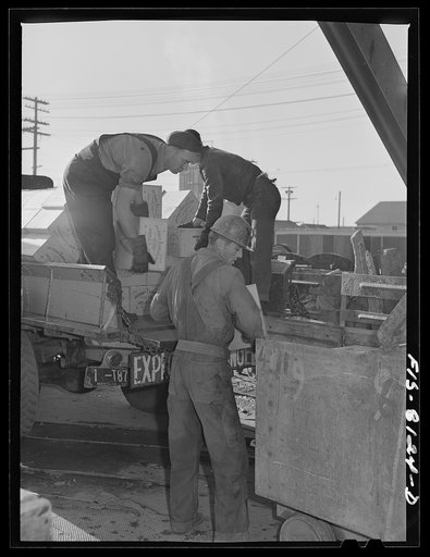 Butte, Montana. Anaconda Copper Mining Company. Men unloading powder at headframe of mine; it will be taken below by the cage