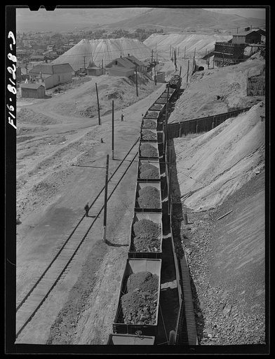 Untitled photo, possibly related to: Butte, Montana. Anaconda Copper Mining Company. Train of copper ore cars leaving the mines in Butte for the smelter at Anaconda