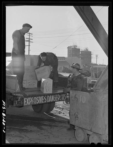 Butte, Montana. Anaconda Copper Mining Company. Men unloading powder at headframe of mine; it will be taken below by the cage