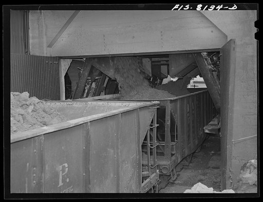 Butte, Montana. Anaconda Copper Mining Company. Loading copper ore into fifty-ton cars for shipment to the smelter at Anaconda
