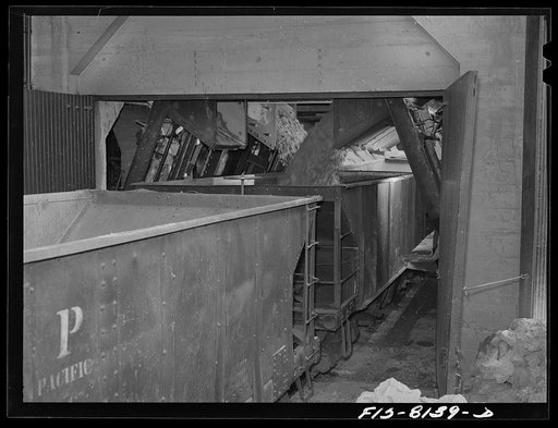 Butte, Montana. Anaconda Copper Mining Company. Loading copper ore into fifty-ton cars for shipment to the smelter at Anaconda