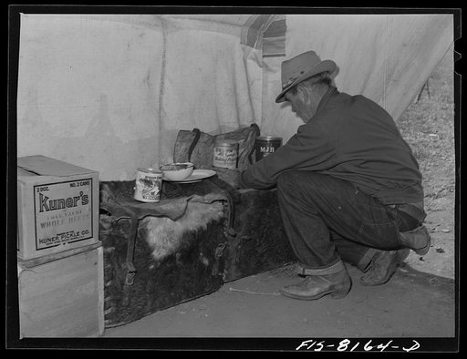 Untitled photo, possibly related to: Gravelly Range, Madison County, Montana. Sheepherder getting supplies from a box