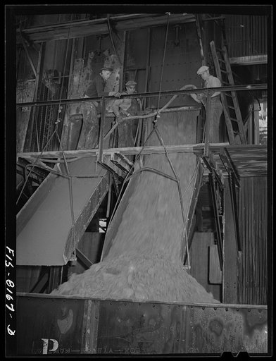 Butte, Montana. Anaconda Copper Mining Company. Loading copper ore into fifty-ton ore cars for transporting to smelter at Anaconda, Montana