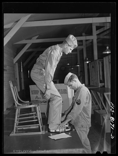 Fort Belvoir, Virginia. Issuing shoes to George Camblair at the clothing warehouse at camp
