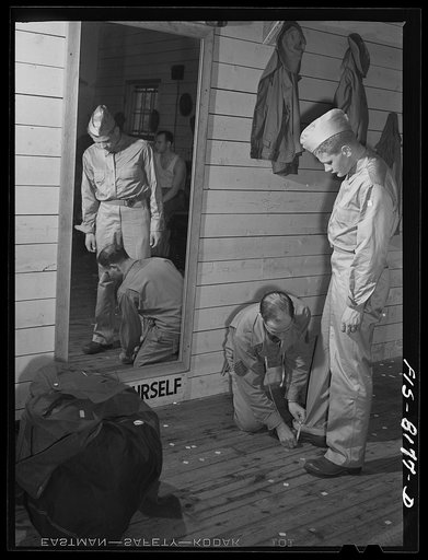 Fort Belvoir, Virginia. A tailor making any alterations that are necessary in George Camblair's uniform