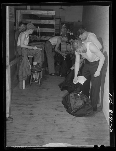 Fort Belvoir, Virginia. Issuing a duffle bag to George Camblair at the clothing warehouse