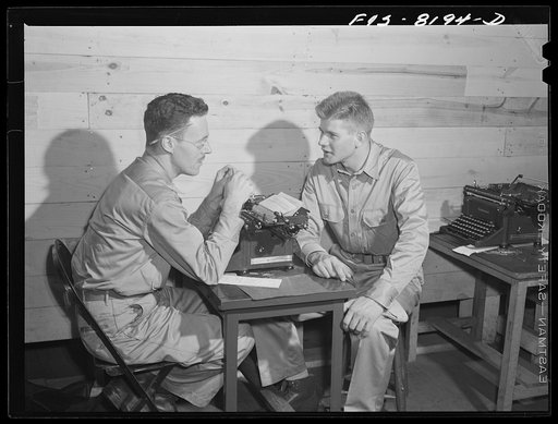 Fort Belvoir, Virginia. George Camblair discussing insurance problems with an officer at the reception center