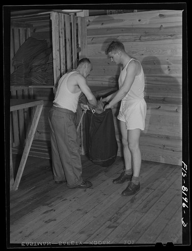 Fort Belvoir, Virginia. At the clothing warehouse George Camblair started with nothing and comes out completely equiped with clothing