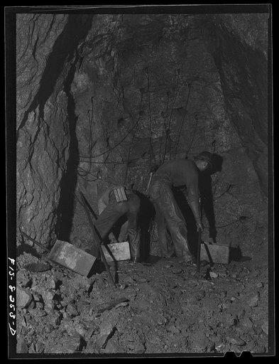 Butte, Montana. Anaconda Copper Mining Company. Tamping in the powder and placing wires for blasting in copper mine