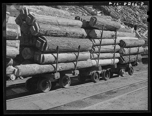 Butte, Montana. Anaconda Copper Mining Company. Timbers are loaded onto trucks for transporting to the cage which carries them underground to the copper mine