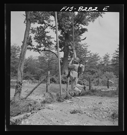 Fort Belvoir, Virginia. Sergeant George Camblair getting rigorous physical training on the obstacle course