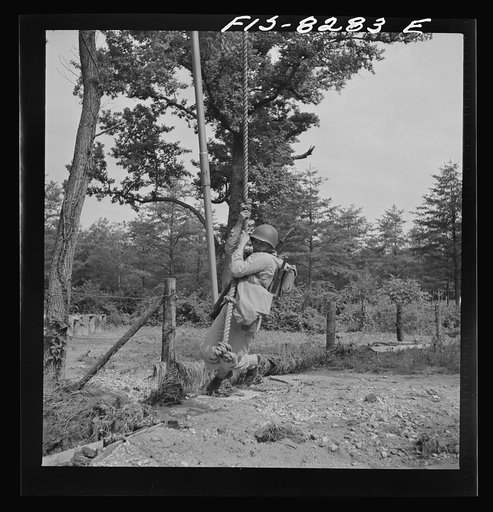 Untitled photo, possibly related to: Fort Belvoir, Virginia. Sergeant George Camblair getting rigorous physical training on the obstacle course