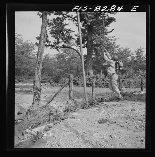 Untitled photo, possibly related to: Fort Belvoir, Virginia. Sergeant George Camblair getting rigorous physical training on the obstacle course