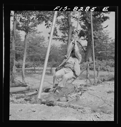 Fort Belvoir, Virginia. Sergeant George Camblair getting rigorous physical training on the obstacle course